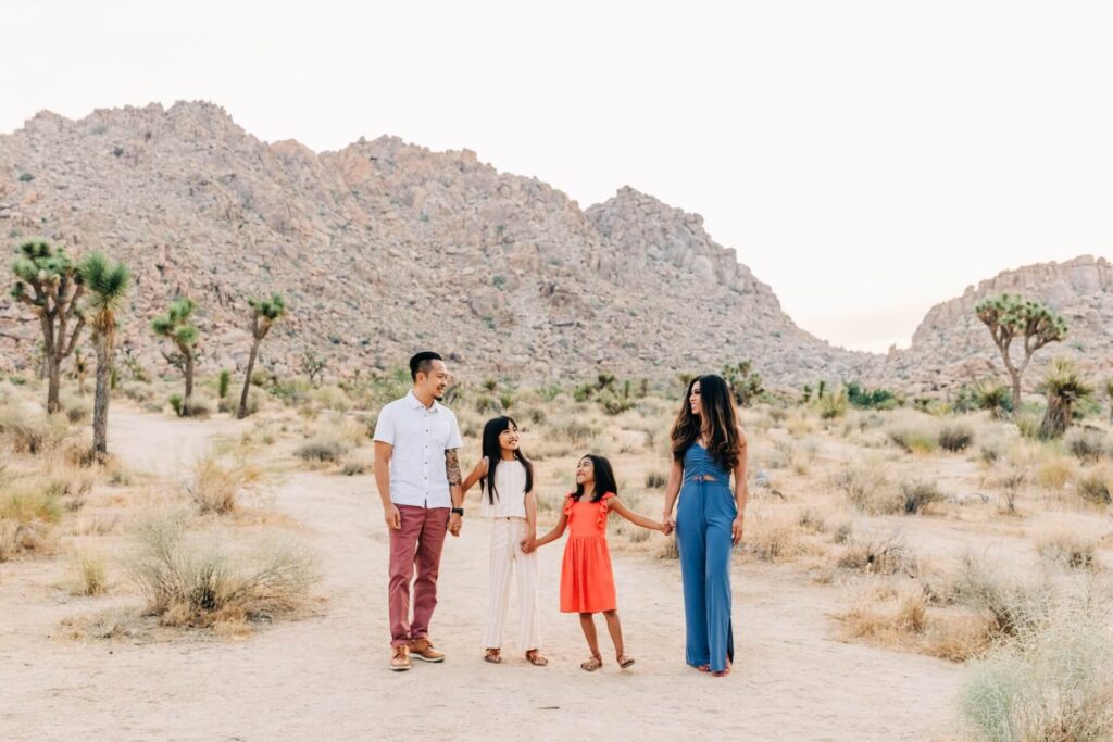 A family walking in Joshua Tree National Park on a family photoshoot with Flytographer.