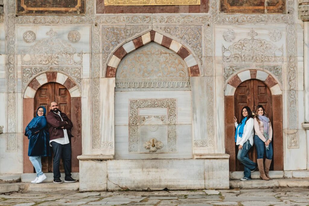 Friends standing in front of a building in Istanbul, Turkey on a friends photoshoot with Flytographer.