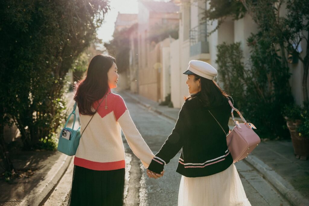 Friends holding hands in Athens, Greece on a friends photoshoot with Flytographer.