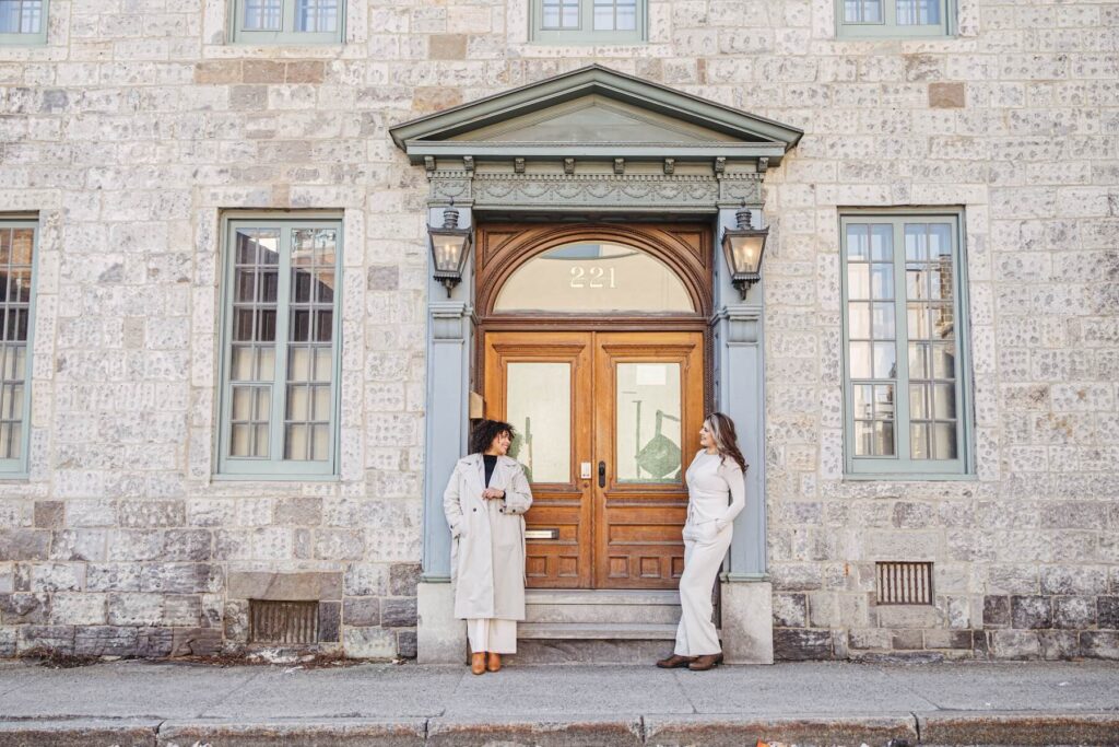 Ladies standing in front of an old door in Montreal, Quebec, Canada on a friends photoshoot with Flytographer.