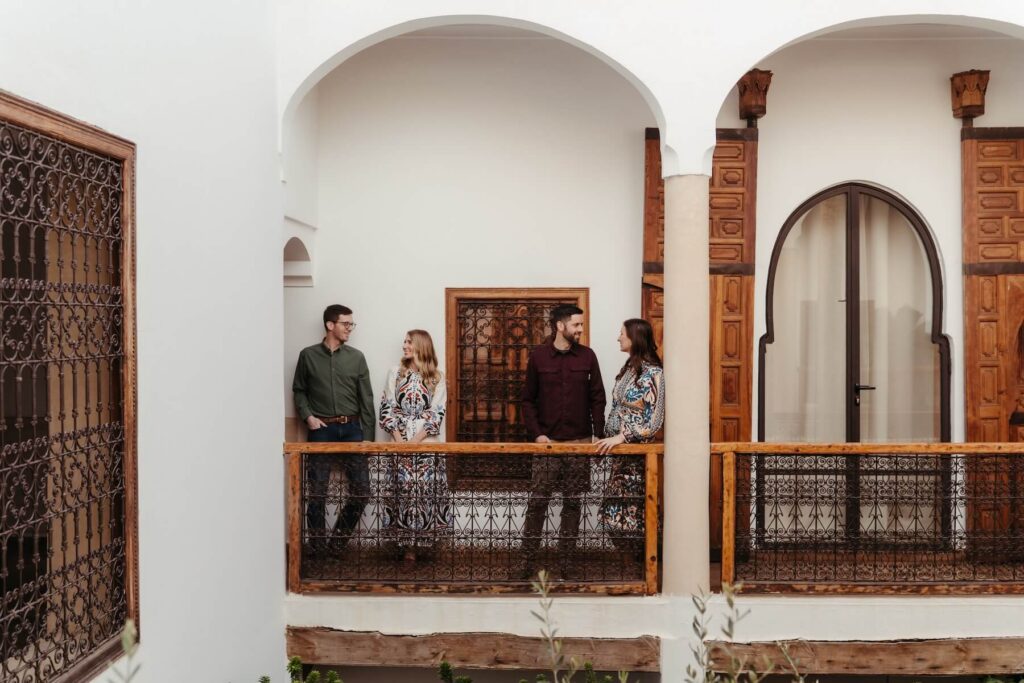 Friends standing in a Riad in Marrakesh on a friends photoshoot with Flytographer in Morocco,