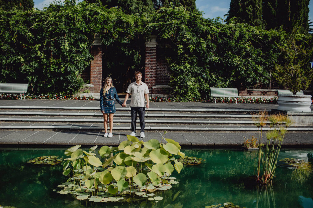 A couple holding hands on a couples photoshoot in Auckland, New Zealand with Flytographer