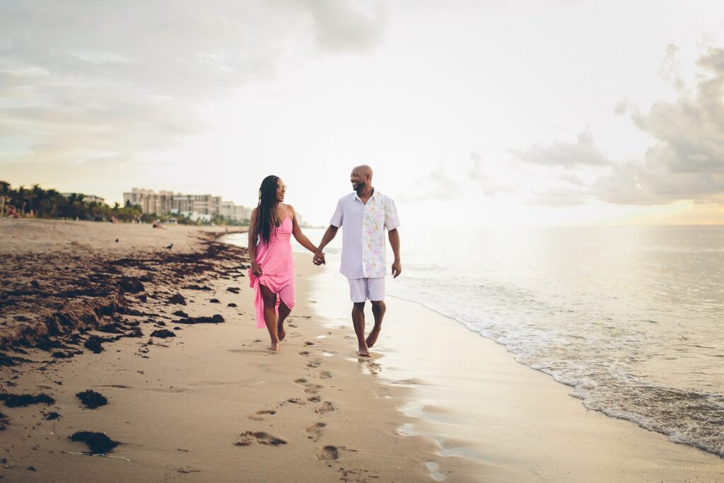 A couple walking on the beach in Miami, Florida at Lummus Park & Beach on a couples photoshoot with Flytographer.