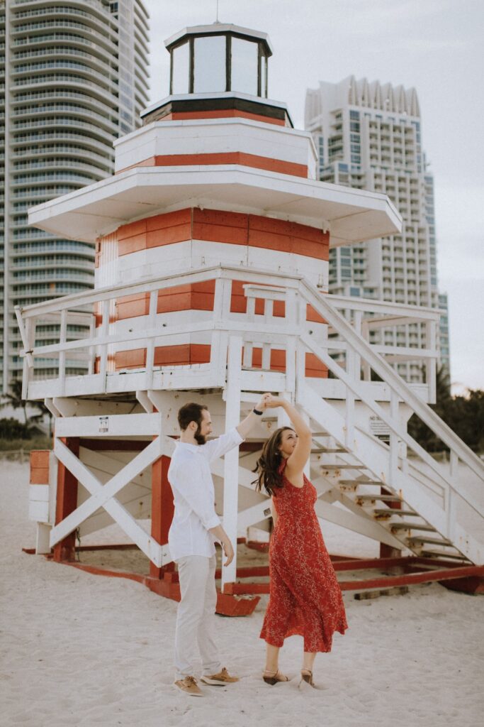 A couple dancing on the beach in Miami, Florida at  South Pointe Park & Beach on a couples photoshoot with Flytographer.