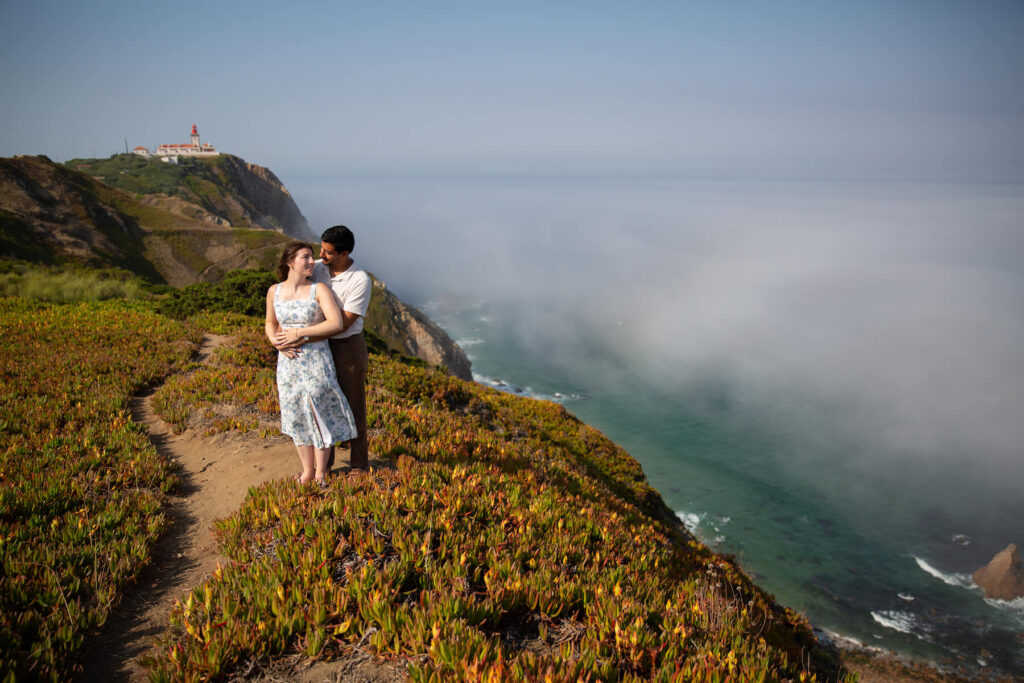 A couple hugging on the coast of Portugal by Sintra on a couples photoshoot with Flytographer