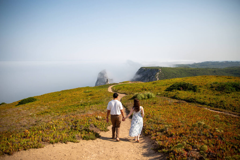 A couple walking on the coast of Portugal by Sintra on a couples photoshoot with Flytographer