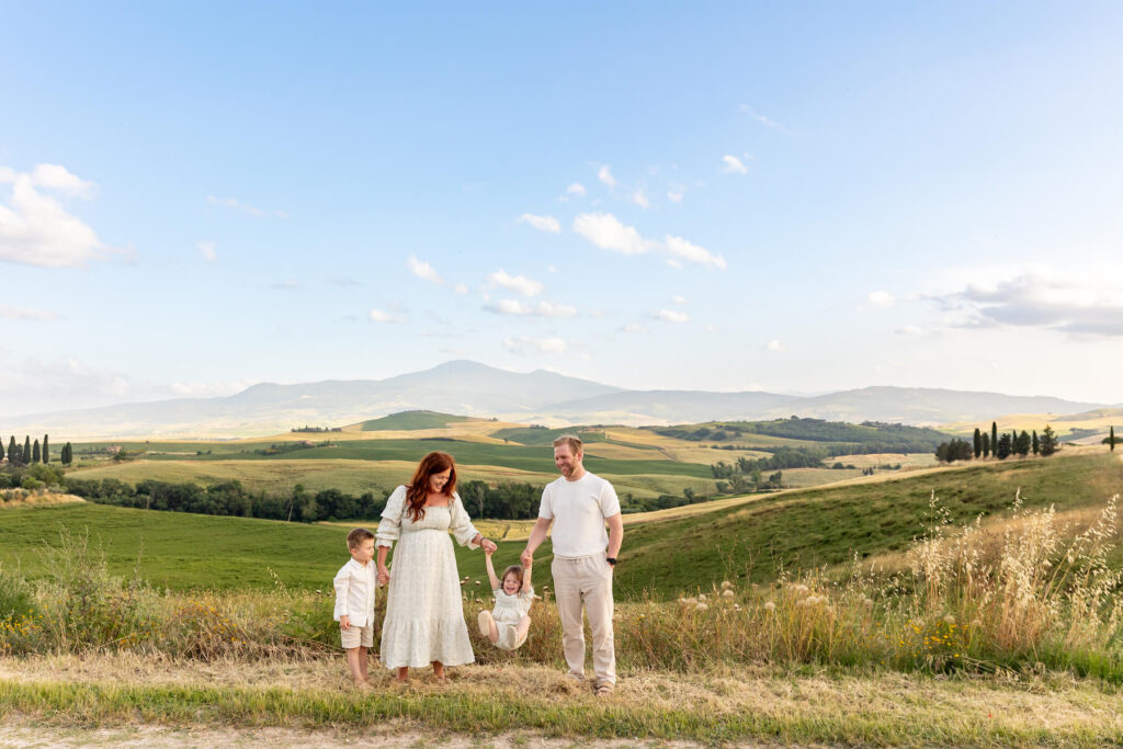 A family holding hands in Tuscany on a family photoshoot with Flytographer in Italy.