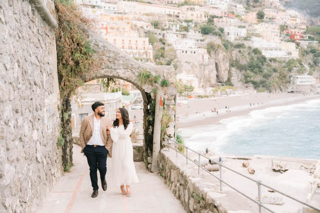 A couple walking on the Amalfi Coast, which is one of the best places to visit in Italy, on a couples photoshoot with Flytographer.