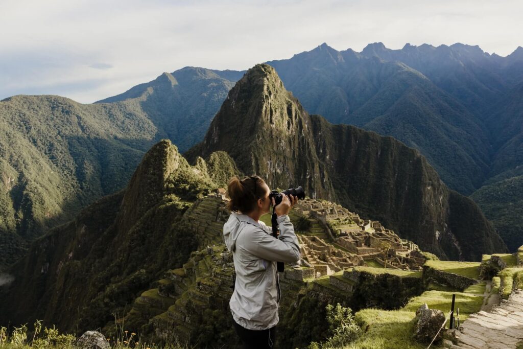 Woman taking a photo of Machu Picchu on a photoshoot with Flytographer