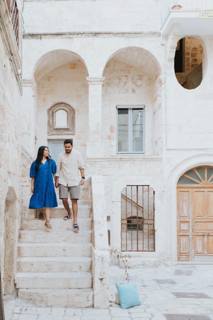 A couple walking in Puglia, which is one of the best places to visit in Italy, on a couples photoshoot with Flytographer.