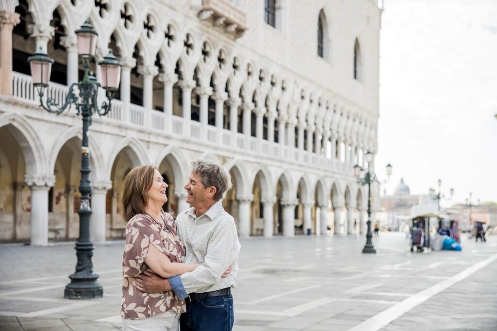A couple hugging in Venice, which is one of the best places to visit in Italy, on a couples photoshoot with Flytographer.
