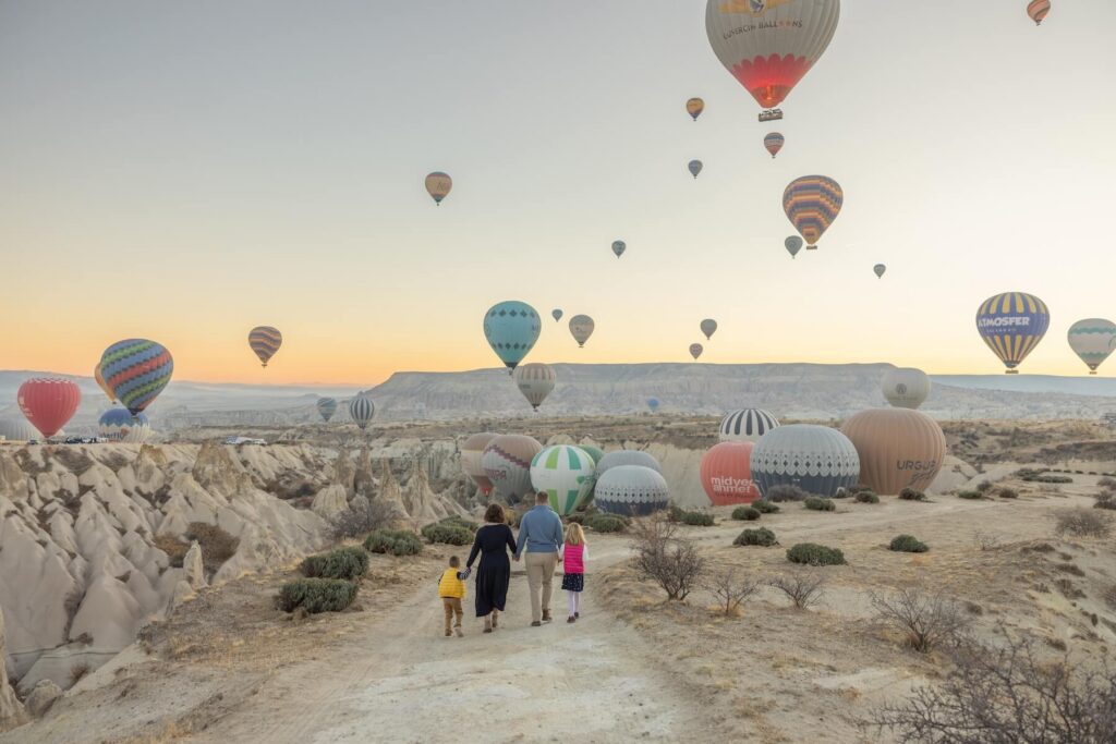 Family walking in Cappadocia Turkey on a family photoshoot with Flytographer