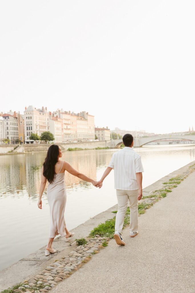 A couple walking in the streets of Lyon, France on a couples photoshoot with Flytographer.