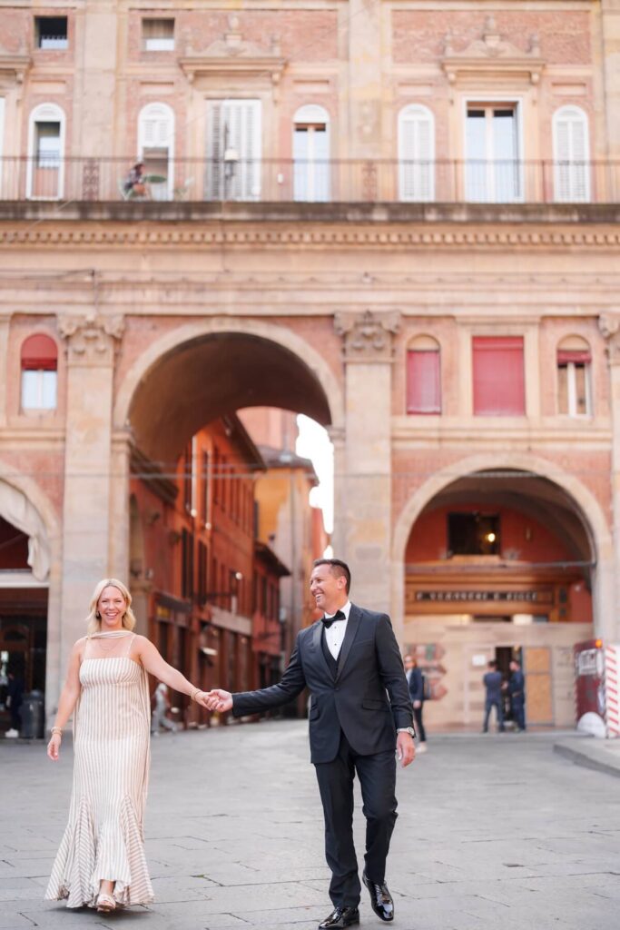 A couple walking in Bologna, which is one of the best places to visit in Italy, on a couples photoshoot with Flytographer.