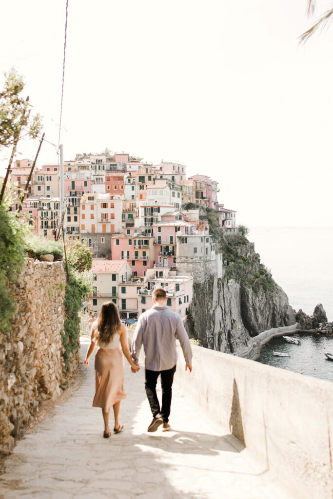 Couple walking in Cinque Terre on a couples photoshoot with Flytographer