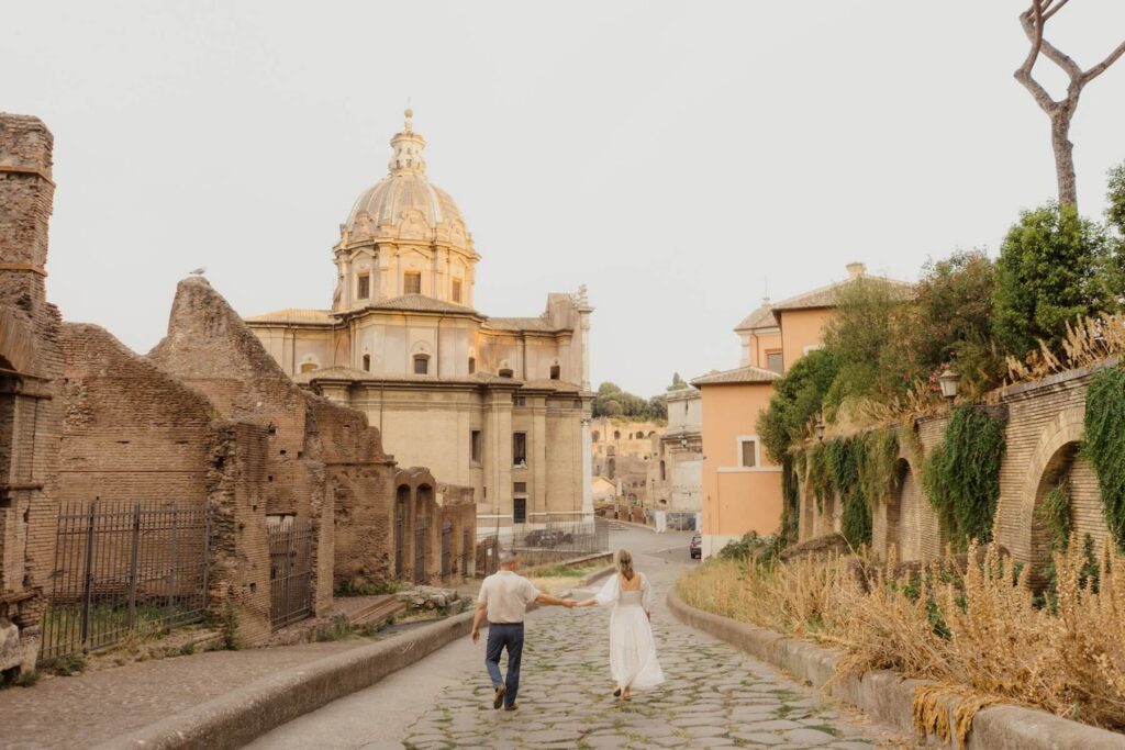 A couple walking in Rome, which is one of the best places to visit in Italy, on a couples photoshoot with Flytographer.