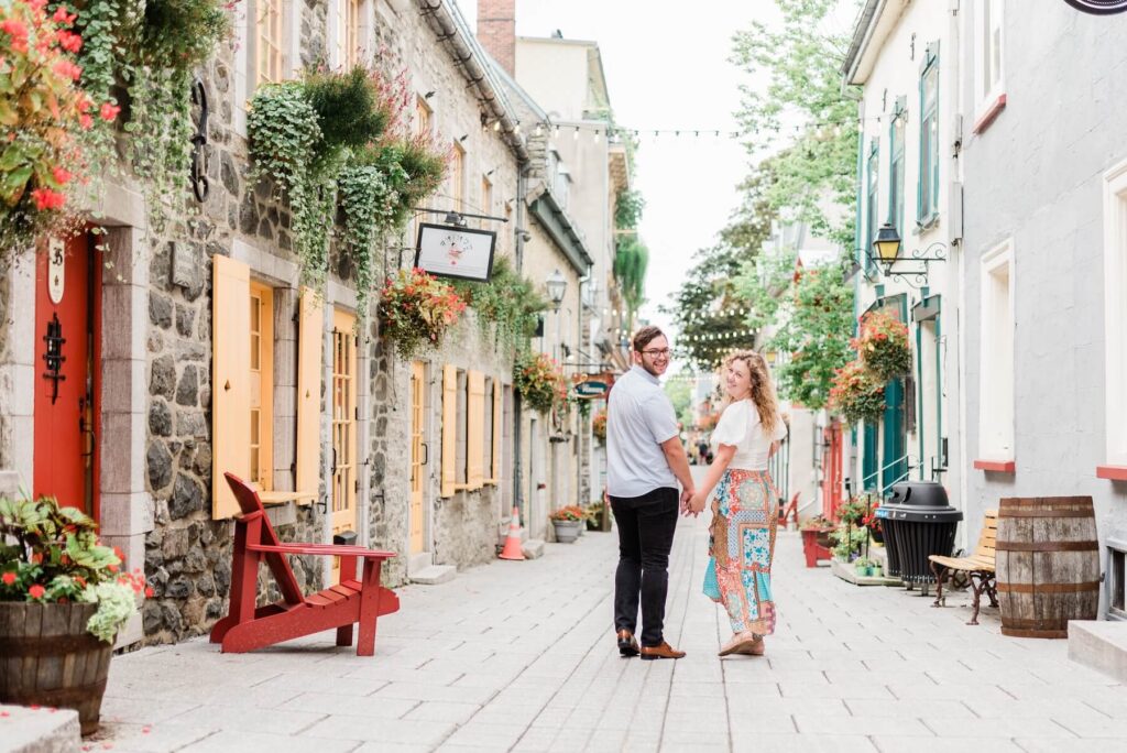 A couple walking together on the streets in Quebec City, QC captured by Flytographer
