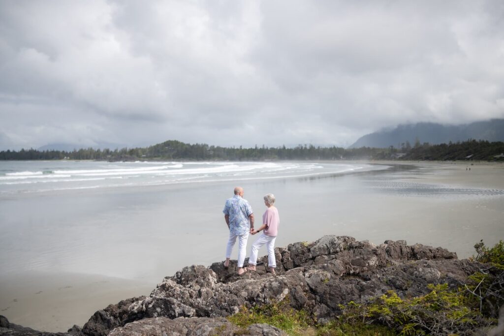 A couple looking at the view in Tofino on vacation in Canada in the summer captured by Flytographer