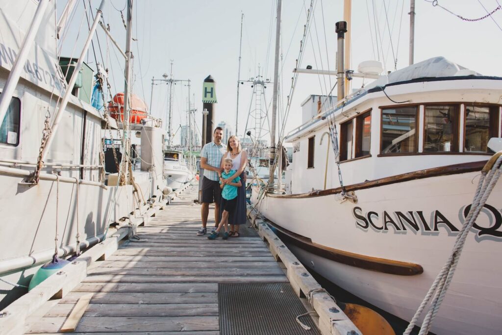 A family at Fisherman's Wharf in Victoria, BC on vacation in Canada in the summer captured by Flytographer