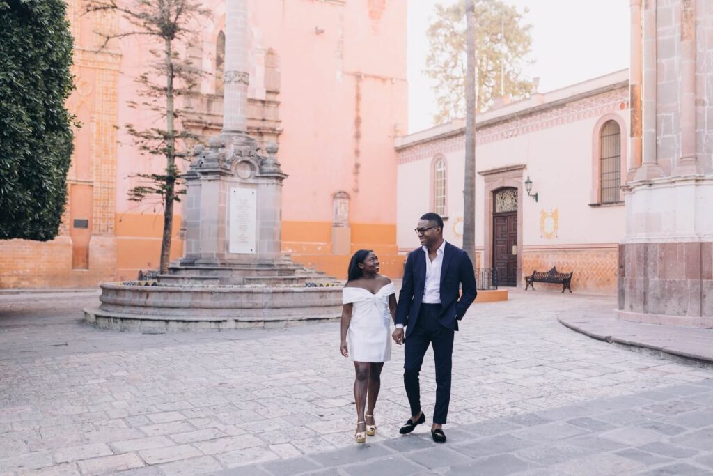 A couple walking near the church in San Miguel de Allende, Mexico, one of the most European cities in North America on a photoshoot with Flytographer