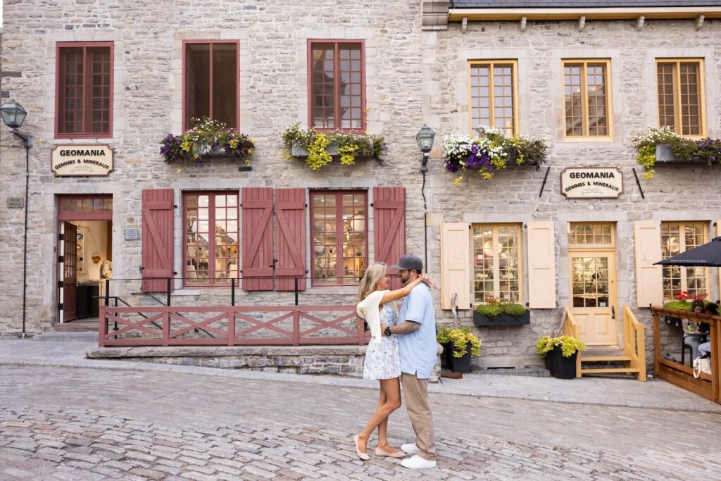 A couple kissing in the street in Quebec City, Canada, one of the most European cities in North America on a photoshoot with Flytographer