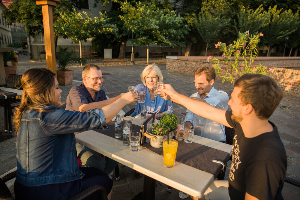 Flytographer Peter in Budapest (on far right) raising a glass with his customers after the shoot.